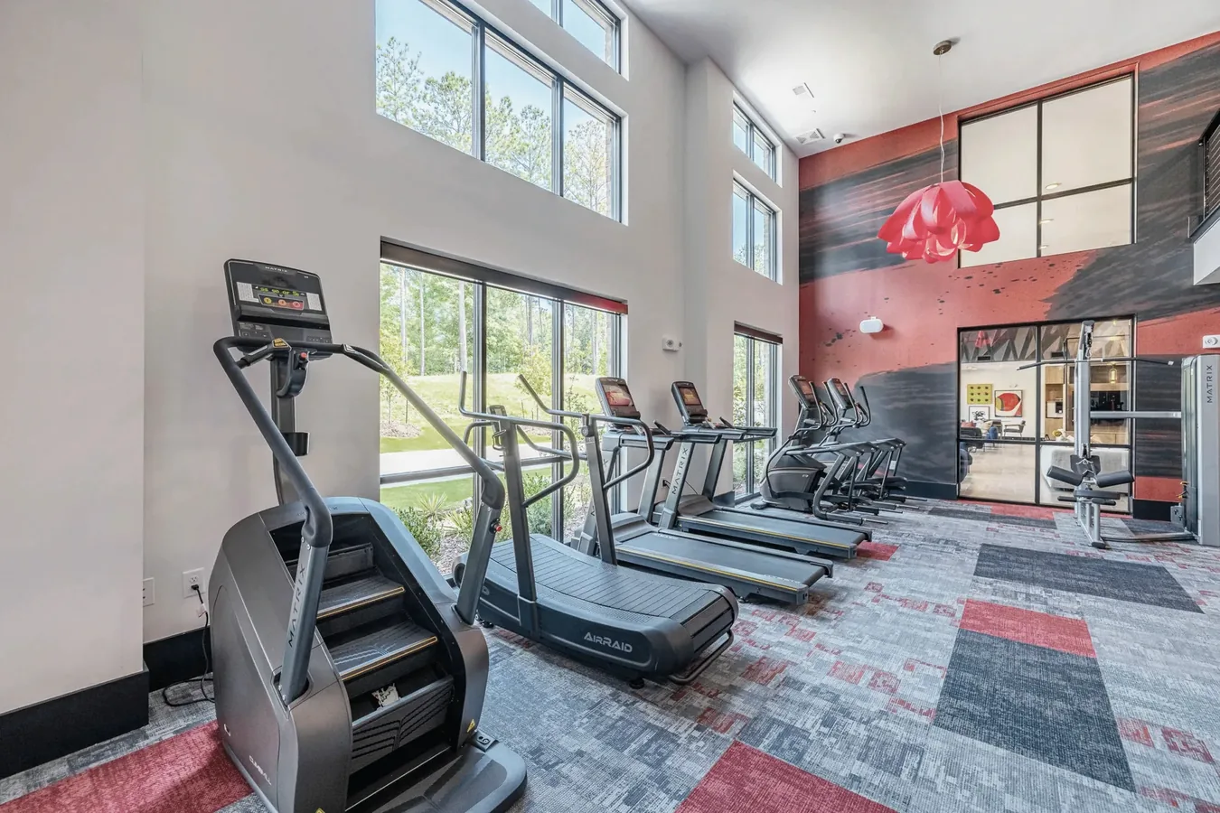 Apartment amenity gym in Birmingham, Alabama, with Matrix treadmills, a curved manual treadmill and stair climber
