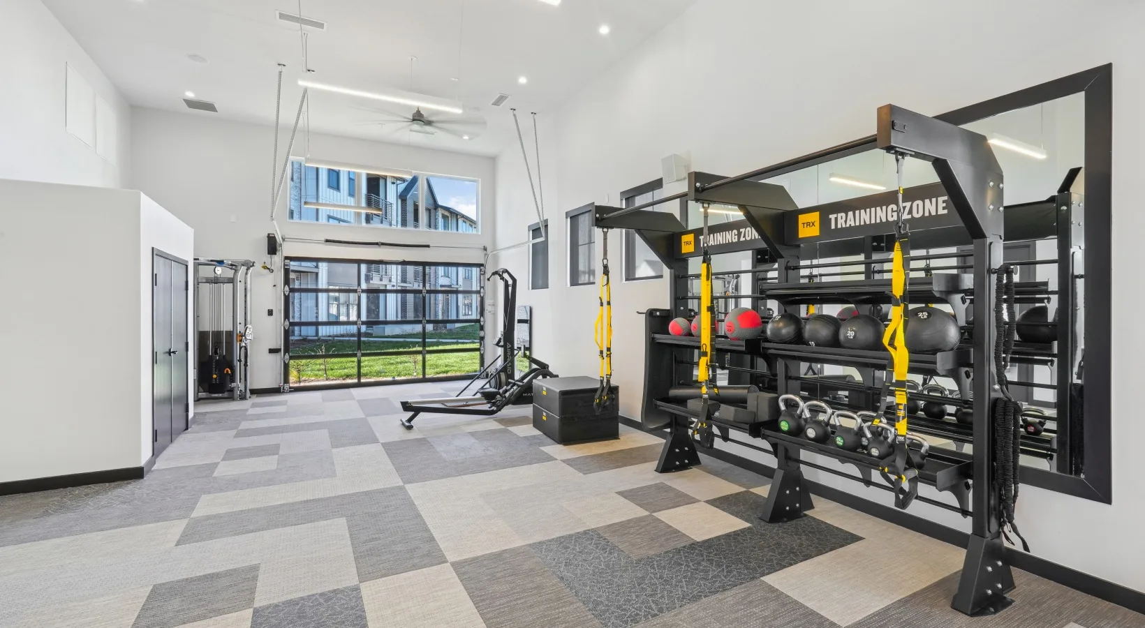 TRX training zone in a Colorado apartment gym with suspension trainers, medicine balls, kettlebells and plyo boxes