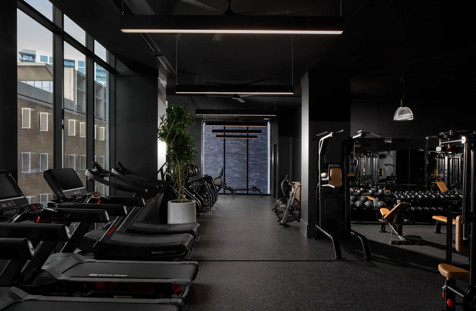 Apartment fitness center in Atlanta, Georgia, with Star Trac treadmills, an Assault AirBike and rubber flooring