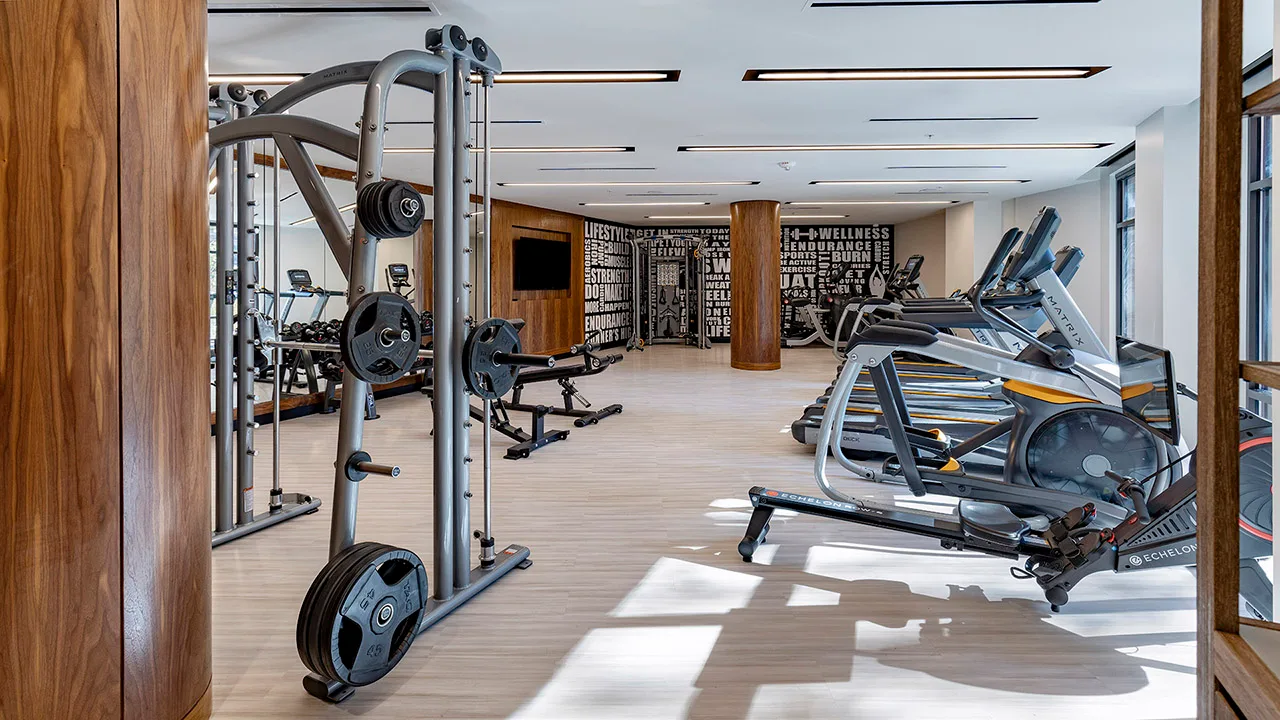 Apartment amenity gym in Bethesda, Maryland, with a Matrix Smith machine, Echelon rower and vinyl plank flooring