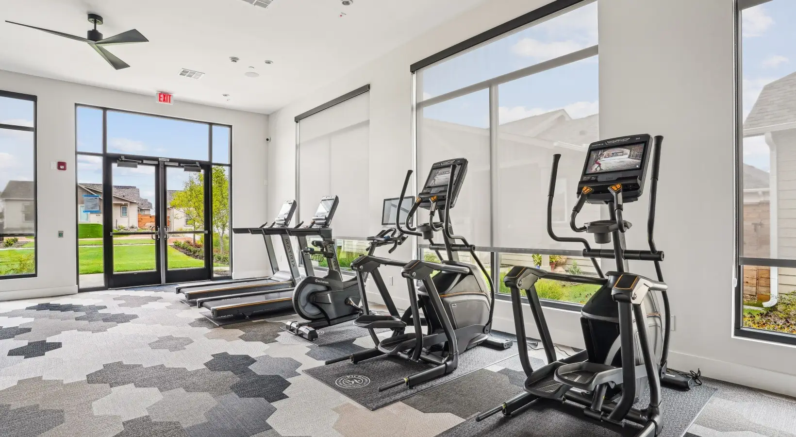 Cardio room in a Fort Worth, Texas apartment gym with Matrix treadmills, ellipticals and an Echelon bike