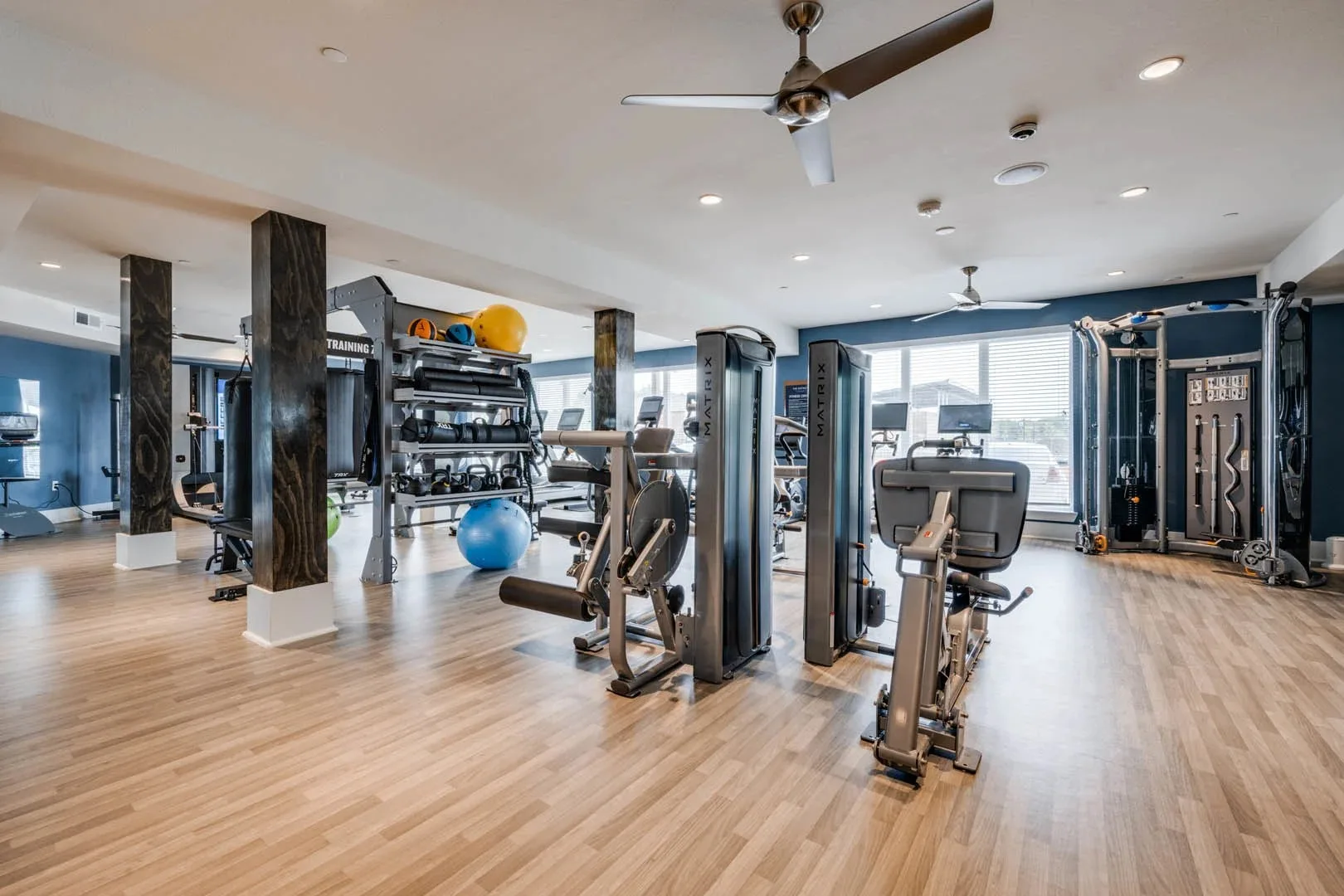 Apartment amenity gym in Little Elm, Texas, with Matrix selectorized machines and a functional trainer