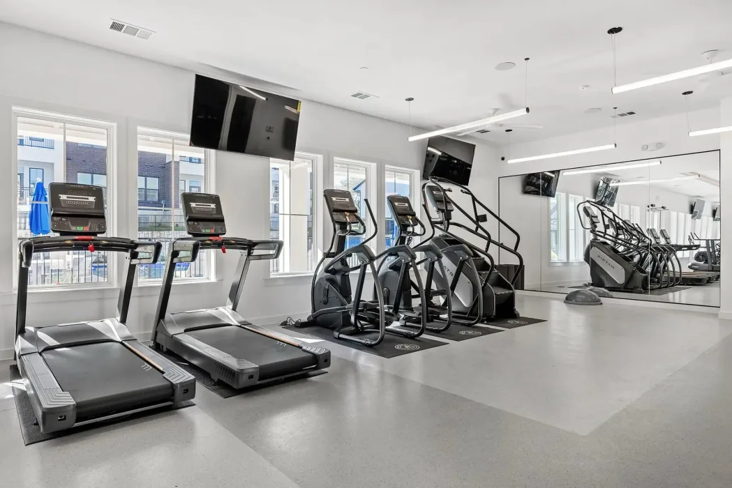 Cardio room in an Austin, Texas apartment gym with Matrix treadmills, ellipticals and a stair climber