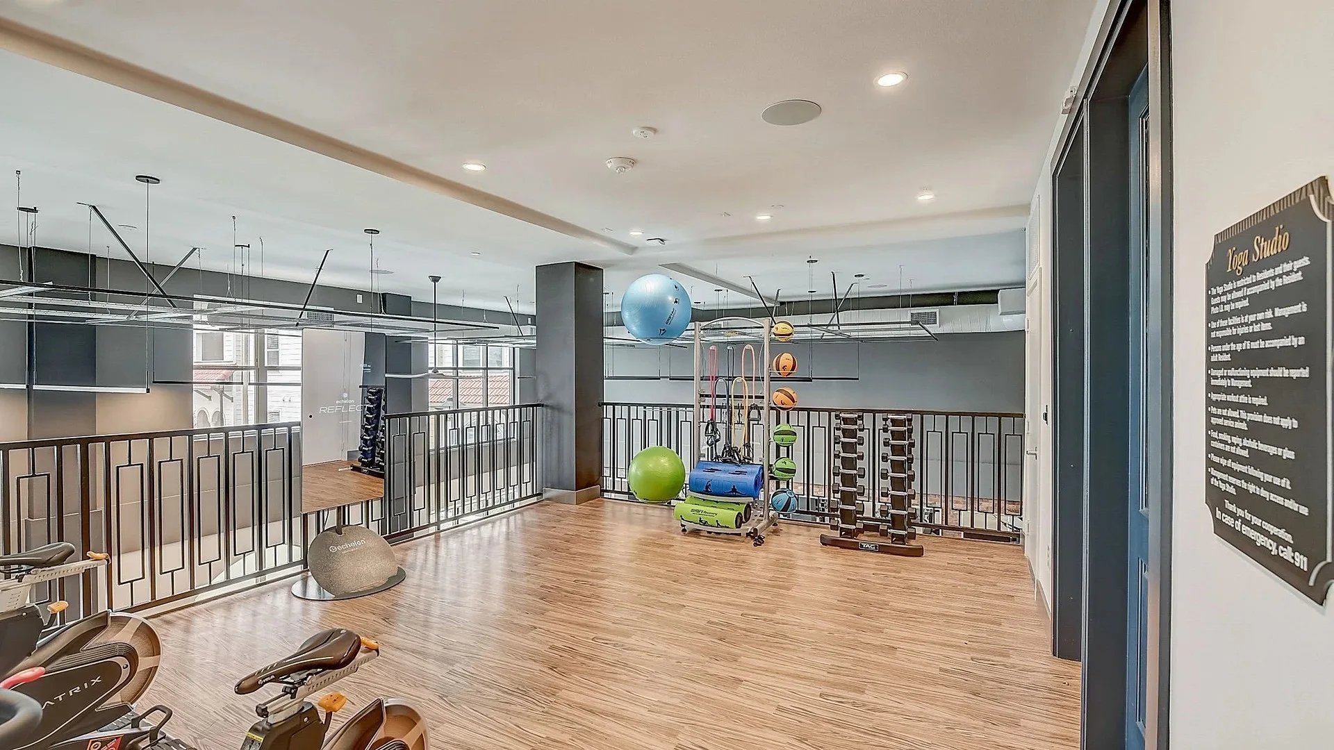Stretching and yoga mezzanine in a Texas apartment community with stability balls, foam rollers and a dumbbell rack