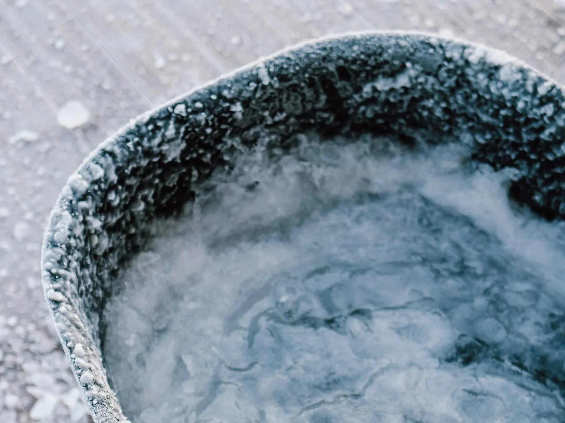 Ice-filled cold plunge tub photographed from above, with frost around the rim