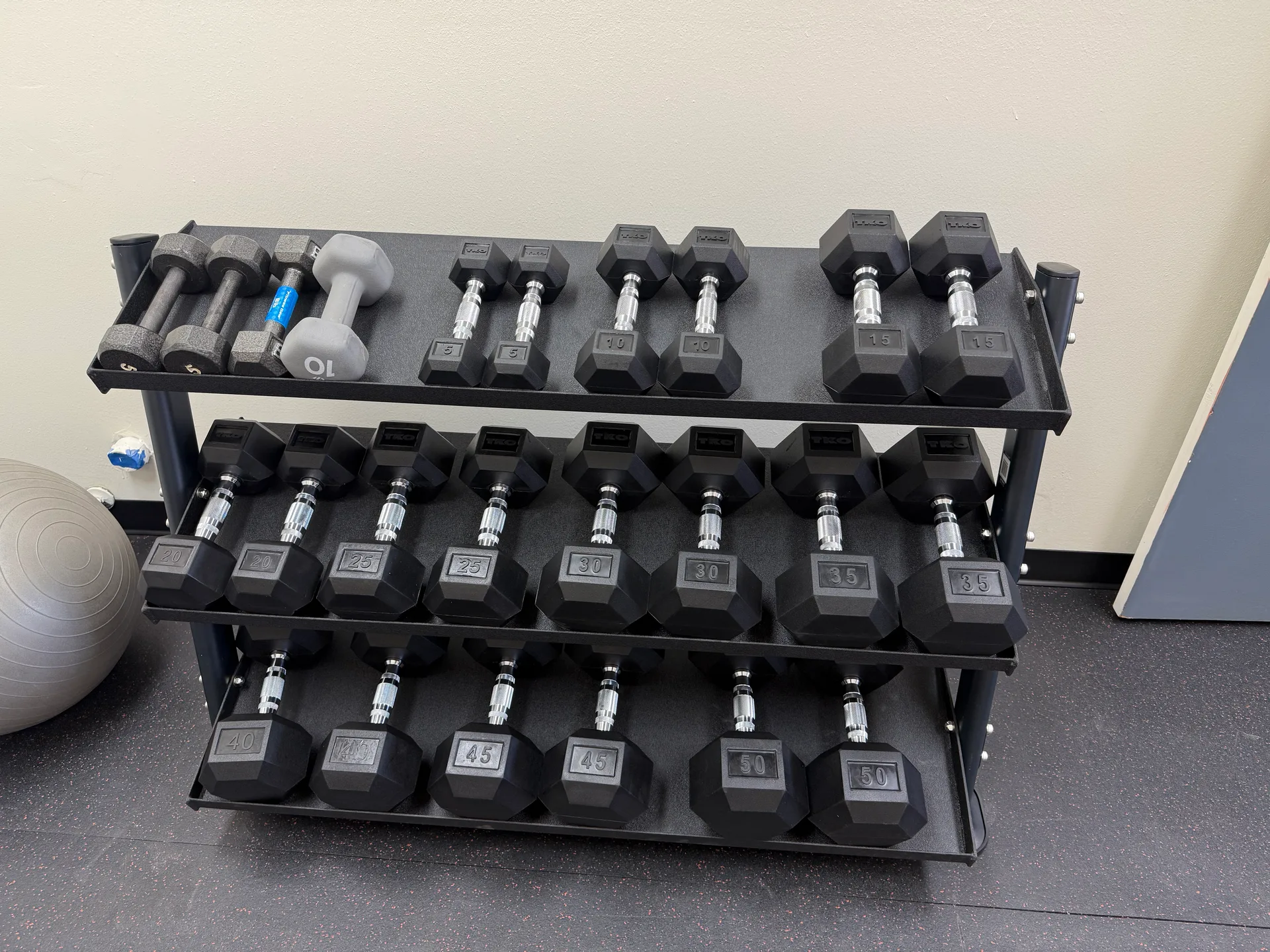 TKO dumbbell rack, full run from light pairs to 50 pounds, at an Arizona apartment amenity gym