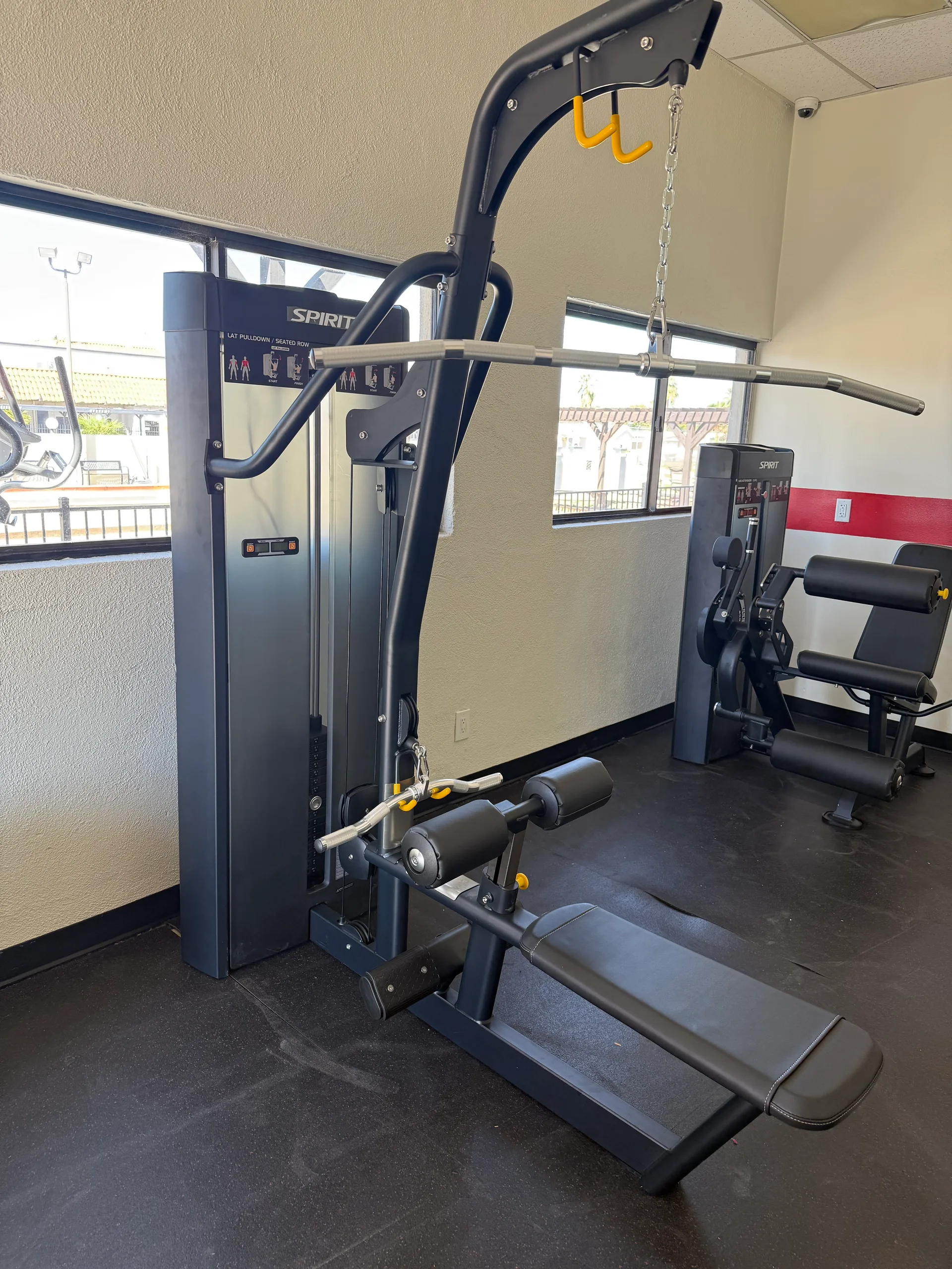 Matrix lat pulldown and leg extension machines at an Arizona apartment amenity gym