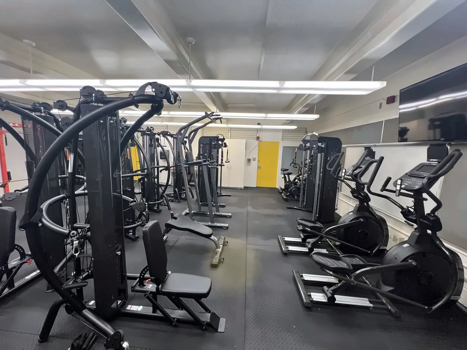 Kahalu'u Elementary School fitness room in Kaneohe, HI: functional trainers, a multi-gym and ellipticals