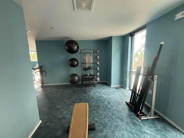Accessory storage rack with medicine balls and bands beside a bench at a Clearwater, Florida community