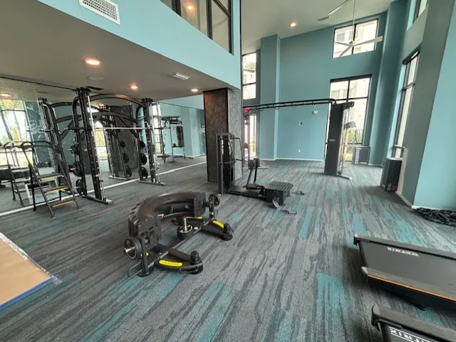 Functional trainer and Smith machine reflected in a mirrored wall at a Clearwater, Florida community