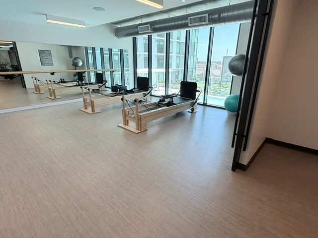 Student housing Pilates studio in College Station, Texas with two reformers, a barre and a mirror wall