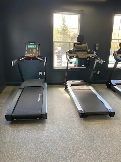 Two treadmills facing a window at a Danbury, Connecticut apartment gym