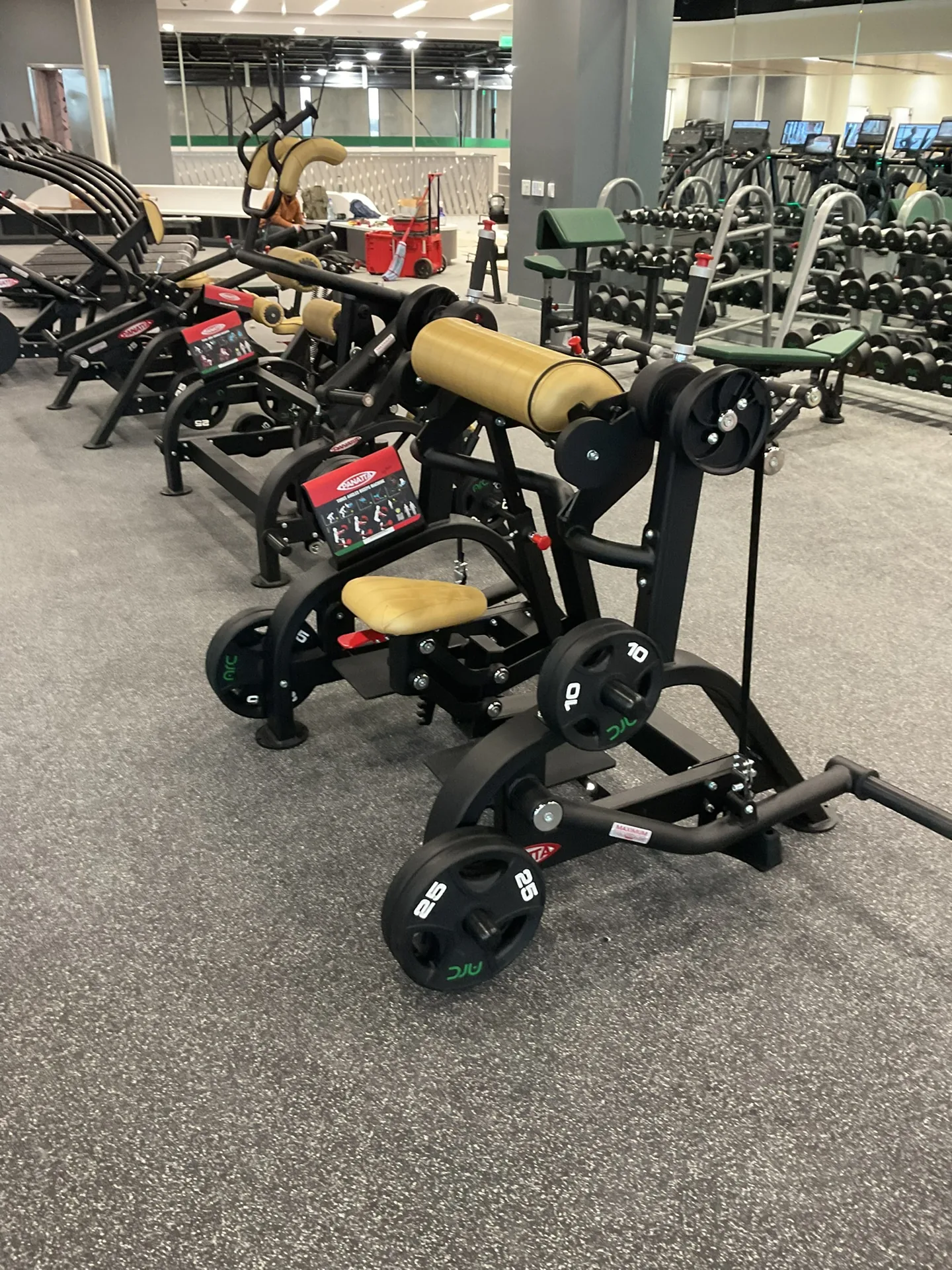 A wide view of the Panatta plate-loaded strength floor, machines in rows with the cardio deck beyond