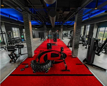 Property logo cut into a red turf training lane