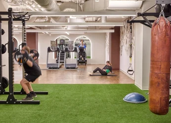 Turf training lane with a sled and rack in a functional fitness zone