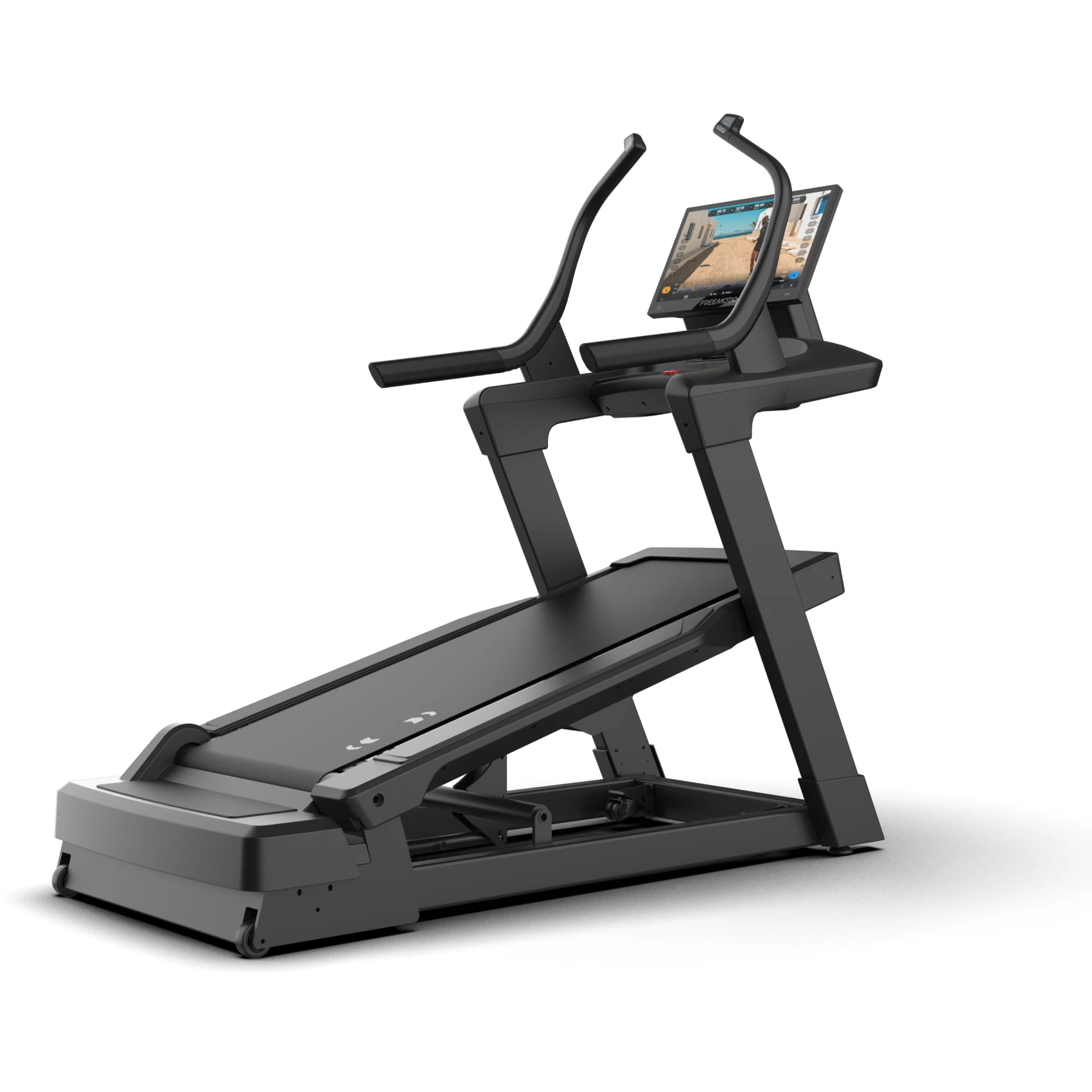Black FreeMotion incline trainer treadmill tilted to a steep uphill angle with a large touchscreen console