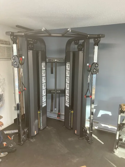 Dual-column functional trainer with cable handles at a Groton, Connecticut apartment gym