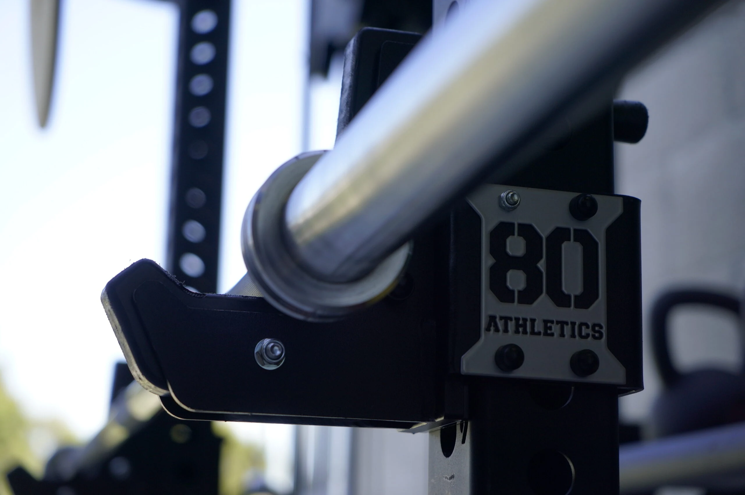 A barbell J-cup on a GYM80 80Athletics functional training rig, marked ‘80 Athletics’