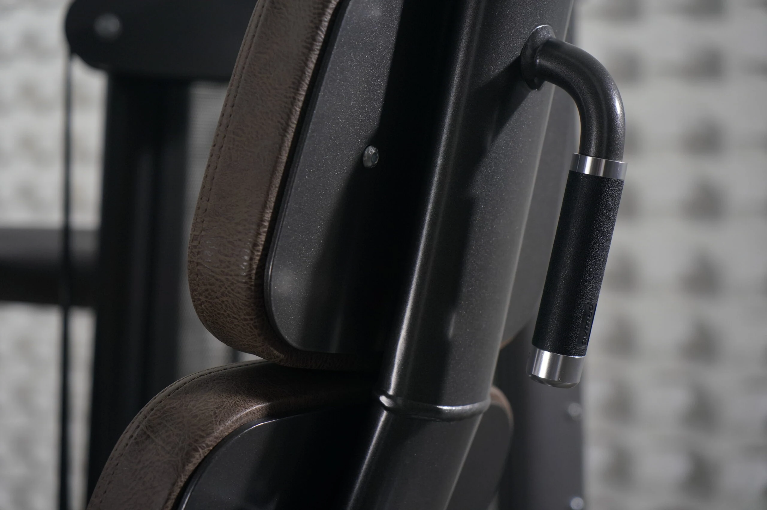 Close detail of a GYM80 Sygnum weight-stack machine’s frame and seat pad