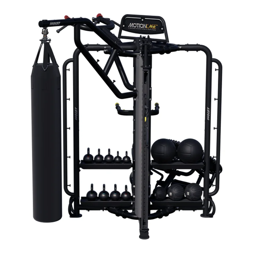 Black HOIST MotionCage Studio rig with a heavy bag, kettlebells and medicine balls on shelves