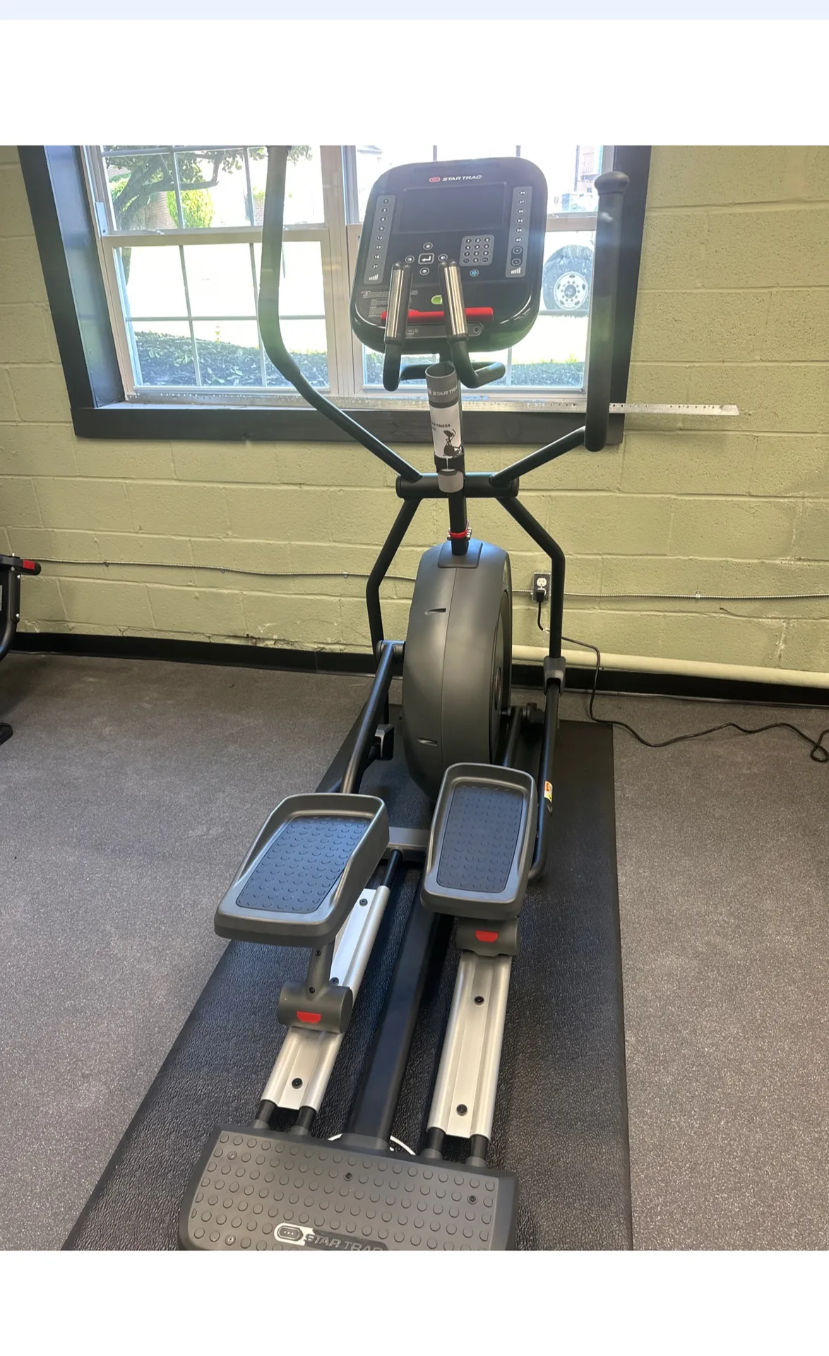 Elliptical cross trainer facing a window at a Nottingham, Maryland apartment gym