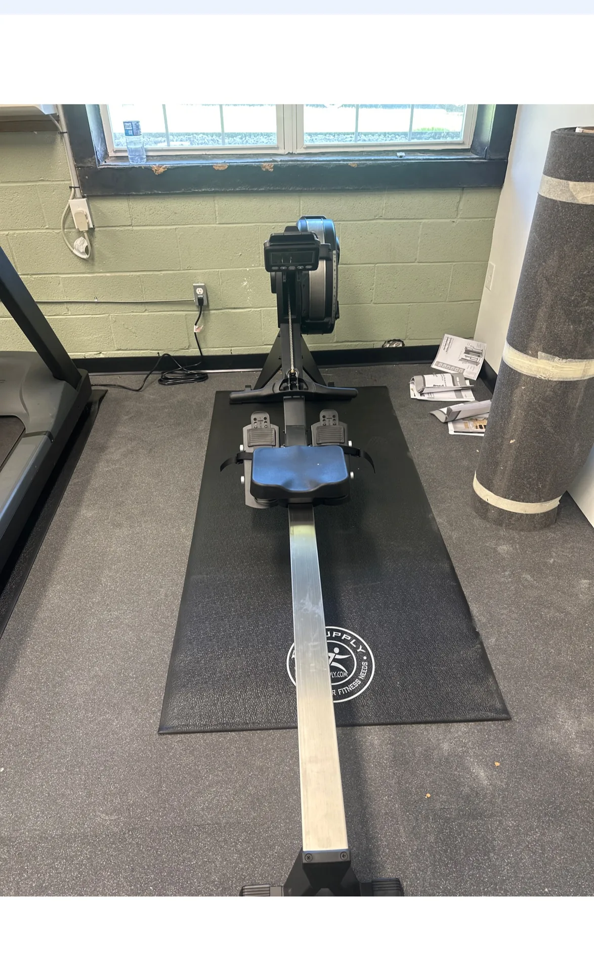 Rowing machine on a mat beneath a window at a Nottingham, Maryland apartment gym
