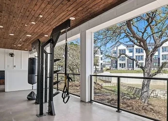Covered patio training area with a functional rig and heavy bag