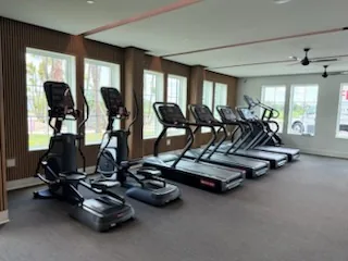 Cardio row of Star Trac treadmills and an elliptical at a Port Charlotte, Florida community fitness center