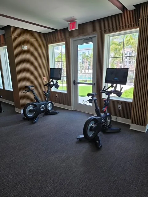 Two Echelon Connect bikes with touchscreen consoles in a Port Charlotte, Florida community fitness room