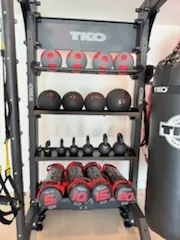 TKO storage rack with slam balls, kettlebells and a heavy bag at a Port Charlotte, Florida community