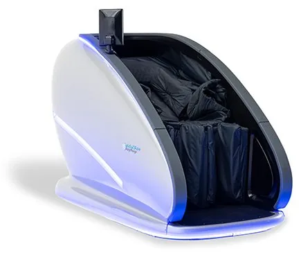 Contrast cryo-massage lounger pod with a padded interior and open shell, sized for an unstaffed recovery corner
