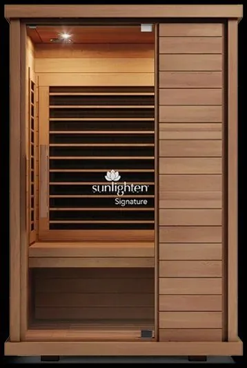 Sunlighten infrared sauna cabin in cedar with a full glass door and interior bench, for an amenity recovery room