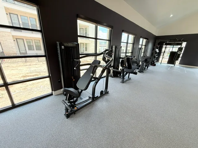 Matrix Versa chest press and strength line along a window wall in a Spring, Texas apartment clubhouse gym