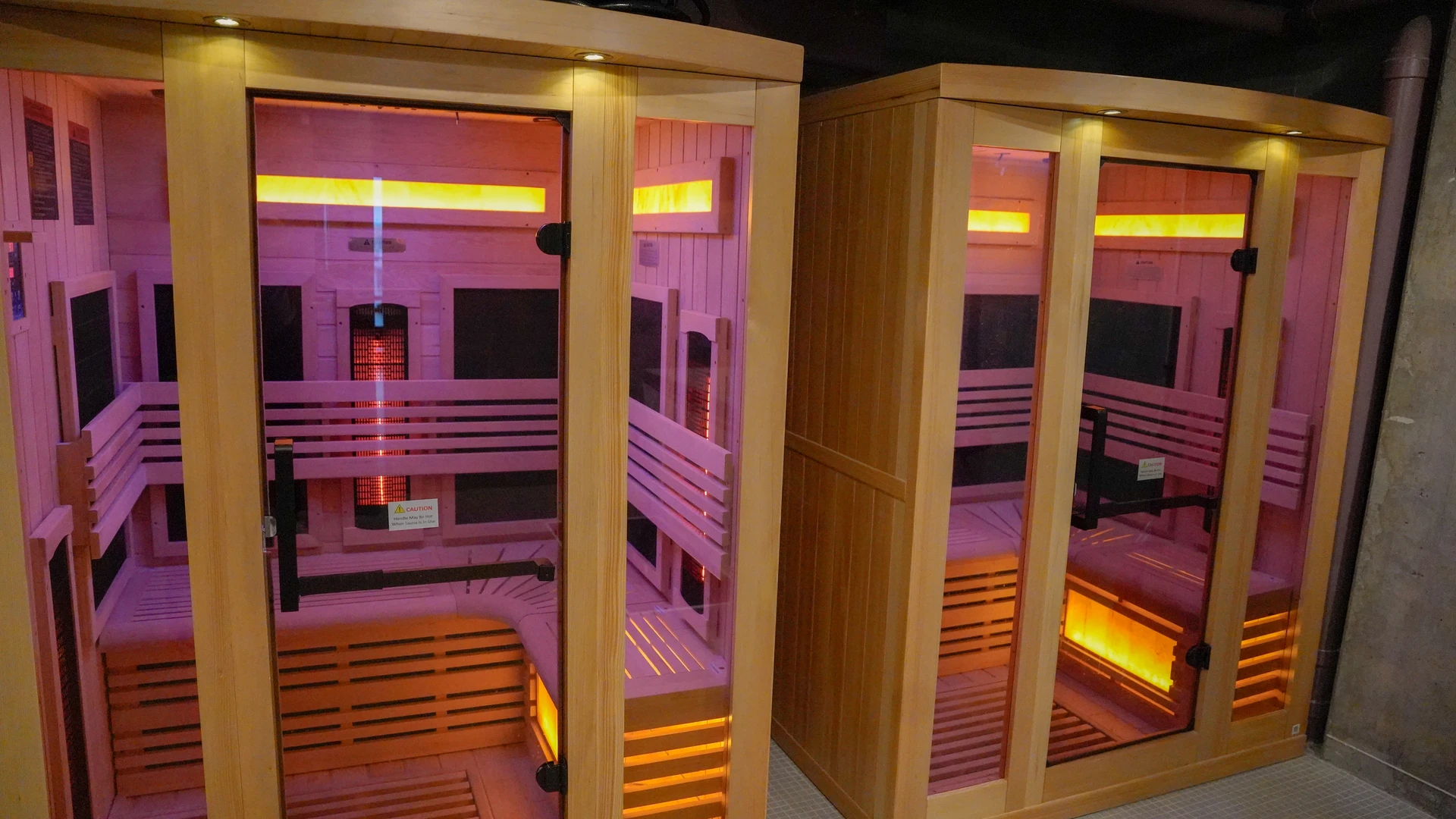 Two Golden Designs infrared sauna cabins in a student housing recovery suite