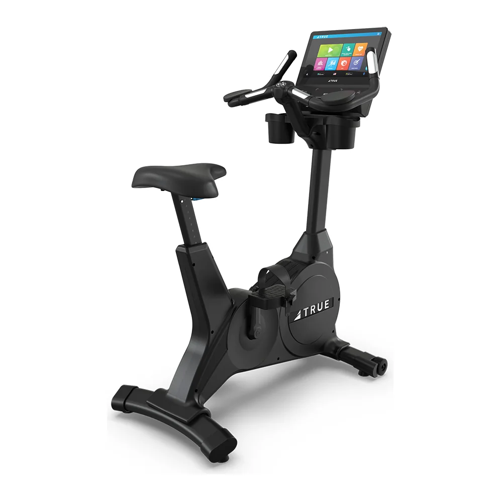 Black TRUE Apex upright bike with a padded saddle, upright handlebars and a touchscreen console