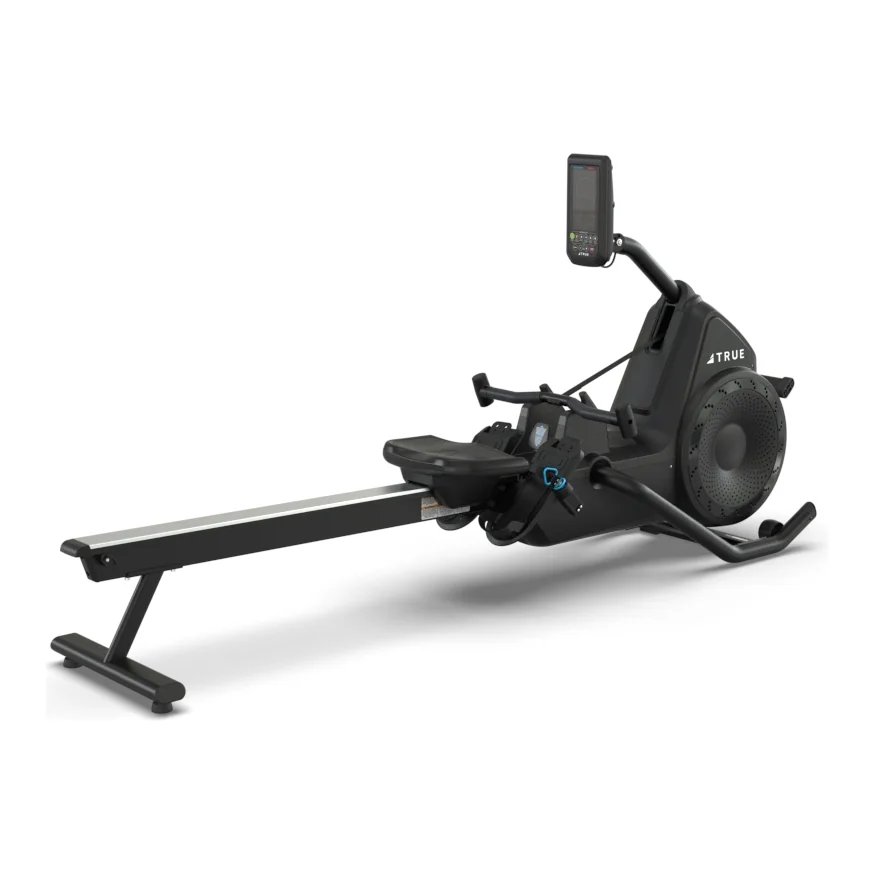 Black TRUE Rō rower with a fan housing, a long rail and sliding seat, and a small console on a post