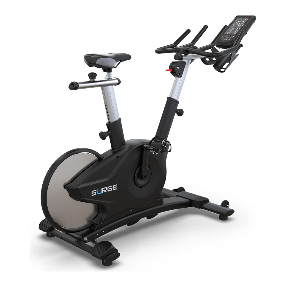 Black and silver TRUE Surge indoor cycle with a covered rear flywheel, multi-position handlebars and a small console