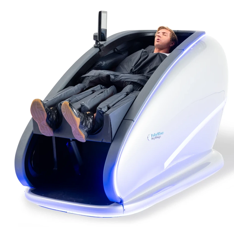 Close-up of a man reclining fully clothed in a white PolarWave dry cold-plunge pod with blue accent lighting