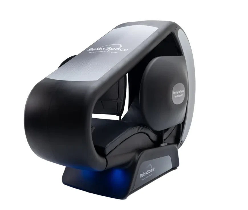 Close-up of a black and silver RelaxSpace enclosed wellness pod with the brand name on its hood