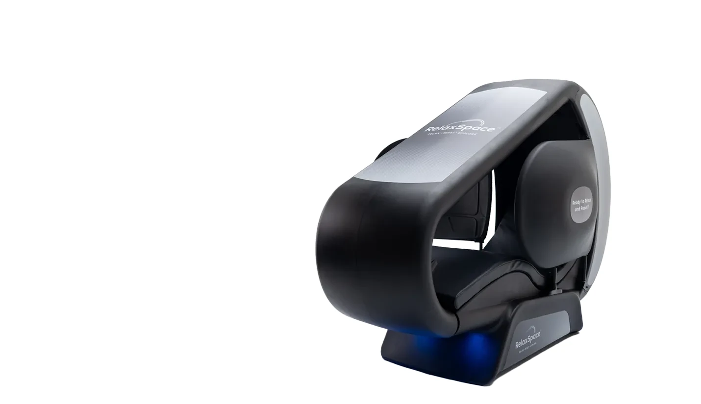 A black and silver RelaxSpace enclosed wellness pod with the brand name on its hood and base